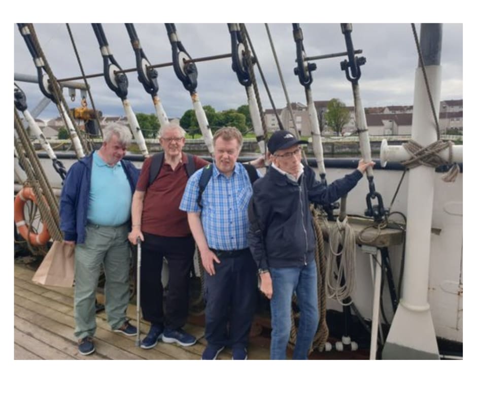 Four service users standing in ship deck